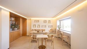 a dining room with tables and chairs and a window at Chinitas Boutique Bellavista in Málaga