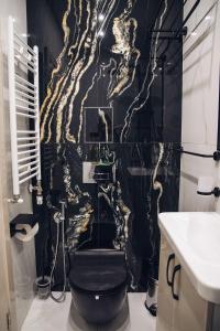 a bathroom with a black and gold wallpaper at Luxurious House with three Deluxe rooms & Free Parking in Sofia