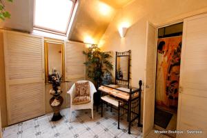 a room with a table and a chair and a mirror at The Mirador Boutique Town House in Swansea