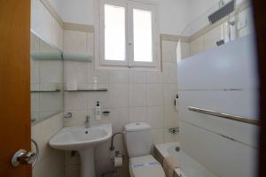 a small bathroom with a toilet and a sink at Neda Hotel in Olympia
