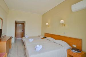 a hotel room with two beds with towels on them at Neda Hotel in Olympia