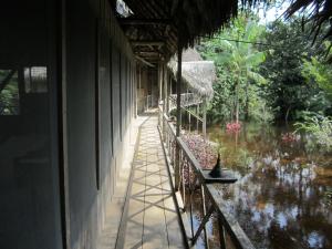 a balcony of a house with a view of the water at Lodge Jungle Wolf Expeditions in Yucuruche