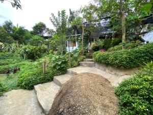 a house with stairs leading up to a garden at DA Family Mini Garden in Ranau