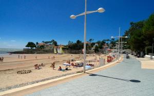 a beach with a lot of people on the sand at Les dunes de Nauzan in Vaux-sur-Mer