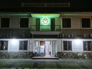 a building with a sign on the front of it at night at Hotel Honai by Capital in Binong