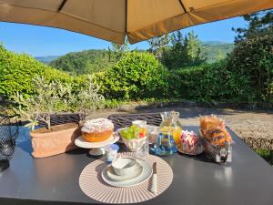 a table with food on it with an umbrella at B&B Greppe68 in Porretta Terme