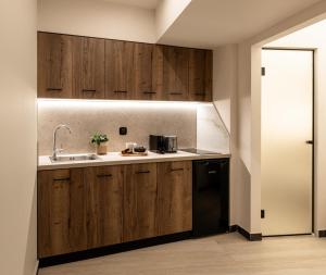 斯基亚索斯镇Serenity Suites, Premium Key Collection的配有木制橱柜和水槽的厨房