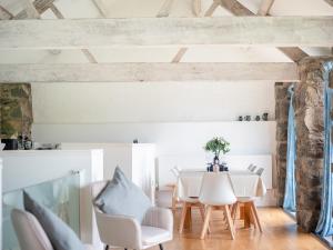 a dining room with a table and chairs at Awel Deg in Arthog +20 photos