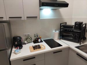 a kitchen with a counter top with a stove top oven at Miranda's Apartment Koukaki in Athens