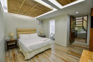 a bedroom with a bed and a staircase in it at Casa Basilisa Hotel & Resort in Guinobatan +37 photos