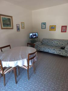 a living room with a table and a couch at Residenza Marina in Ladispoli