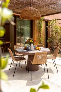 a table and chairs on a patio at Les Maisons Du Sud in Saint-Tropez
