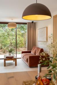 a living room with a couch and a large window at Les Maisons Du Sud in Saint-Tropez