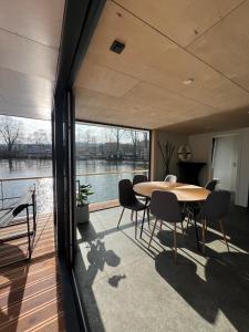 a dining room with a table and chairs on a deck at Prague Stream in Prague