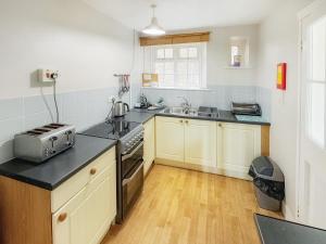 a kitchen with a sink and a stove top oven at Latrigg View - Uk45177 in Threlkeld