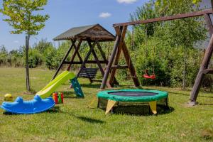 a playground with a slide and a swing set at Rem Garden in Novaci