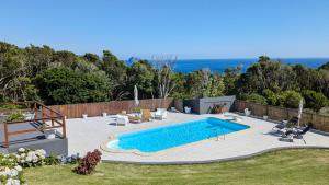 a swimming pool in a yard next to at Villa Capelinhos in Capelo