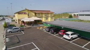 a parking lot with cars parked in front of a building at Felix Hotel in Montecchio Maggiore