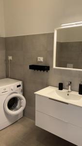 un bagno con lavatrice e lavandino di Al mare da Ersy a Montesilvano