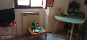 a small room with a table and a table with a plant on it at La casetta dei sogni in Perugia