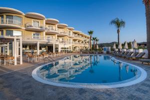 a hotel with a swimming pool in front of a building at Arkadia Hotel in Kipseli