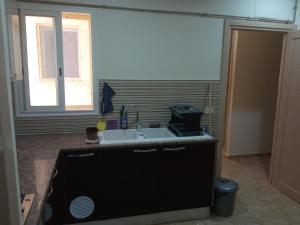 a kitchen with a sink and a window at Paradise Rose in Sfax +7 photos