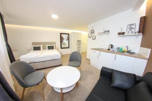 a bedroom with a bed and a table and chairs at Guest House LIKE in Sarajevo
