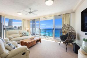 a living room with a view of the ocean at Peninsula Apartments managed by Gchs in Gold Coast