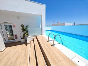 a view of a swimming pool from the balcony of a house at Apartamento a estrenar en Planta Primera C con piscina in Barbate
