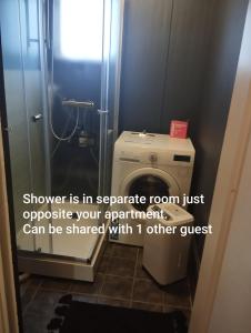 a bathroom with a toilet and a shower with a quote at Rymlig 2-rumssvit nära Centralstationen - Anna Josefinas Stay in Umeå