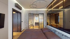 a bedroom with a large bed and a bathroom at Naprstek Urban Retreat in Prague