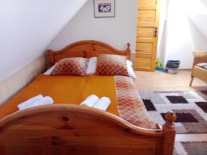 a bedroom with a wooden bed in a room at Dworek Łeba in Łeba +144 photos