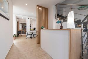 a kitchen and living room with a counter and a table at Room 86 in San Vito lo Capo