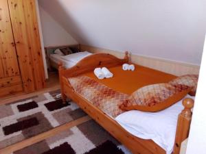 a bedroom with two beds with stuffed animals on them at Dworek Łeba in Łeba
