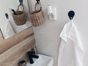 a bathroom with a sink and a mirror and a towel at Apartman EDEN in Jajce +10 photos
