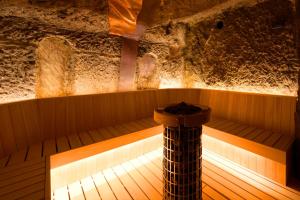 an empty sauna with a wooden floor and a pole at Noto Hyakurakusou in Ogi