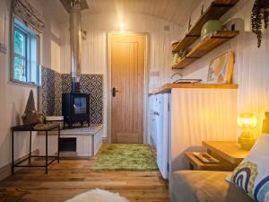 a small living room with a door and a television at Unique Retreat Shepherd's Hut in Robeston Wathen