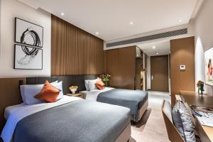 Cama o camas de una habitación en Citadines Songshan Lake Dongguan