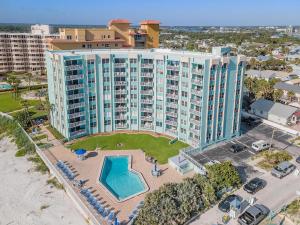 an aerial view of a large apartment building with a pool at Coronado Towers 703 in New Smyrna Beach