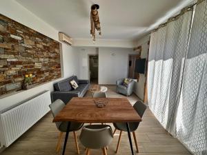 a living room with a wooden table and chairs at Cipollino Place in Karistos