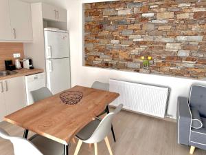 a kitchen and dining room with a wooden table and chairs at Cipollino Place in Karistos +1 photo
