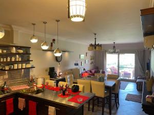 a kitchen and dining room with a table and chairs at Family-Friendly Chalet at Piacera, Ain Sokhna in Ain Sokhna