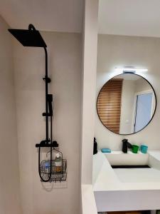 a bathroom with a mirror and a sink at 3 pièces au centre-ville in Sète +21 photos