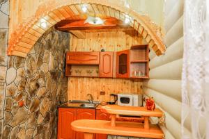 a small kitchen with a table and a microwave at Котедж "У Бойка" in Mykulychyn