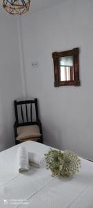 a bedroom with a bed with a mirror and a chair at Apartamentos Bolonia - M a n u e l a in Bolonia