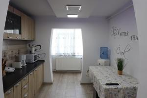 a kitchen with a table and a window in it at Apartament Bianca in Năvodari