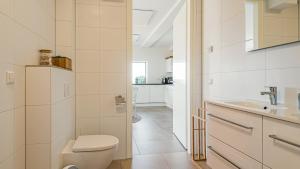 a bathroom with a toilet and a sink at Villa Sea breeze in Bergen aan Zee +31 photos