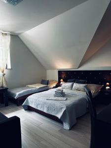 a bedroom with two beds in a attic at Willa Amaretto in Wisła