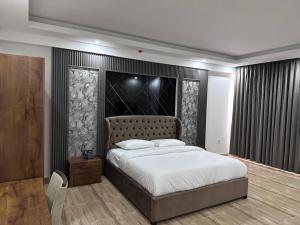 a bedroom with a large bed in a room at itten plaza blue in Salalah
