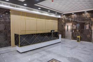 a large lobby with acision at itten plaza blue in Salalah